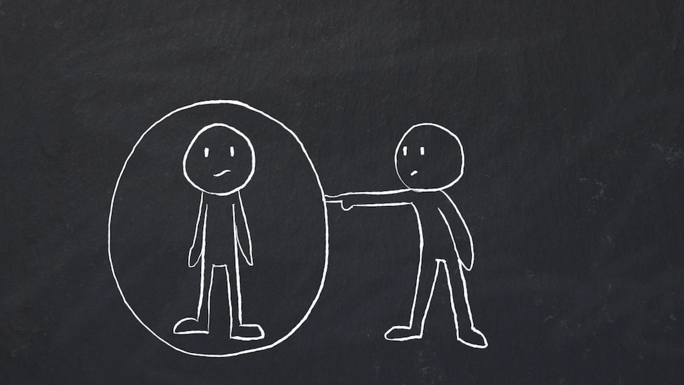 A person protected (or encapsulated) inside a bubble from someone else trying to poke that person